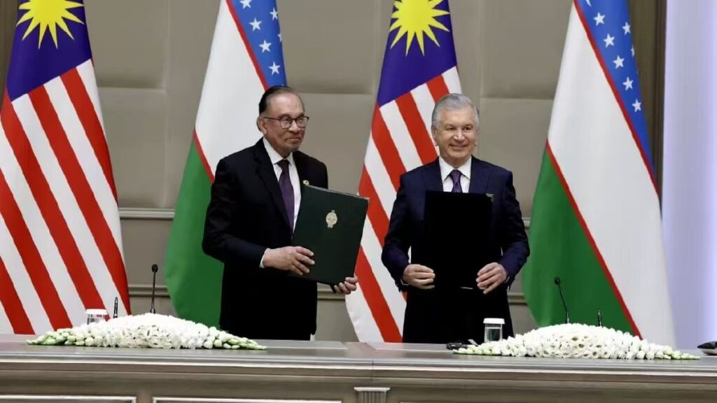 Figure 6: President Shavkat Mirziyoyev of Uzbekistan and Prime Minister Anwar Ibrahim of Malaysia signing a cooperation agreement